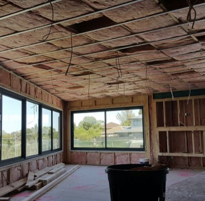 Pink batts fitted between ceiling joists in a Melbourne roof